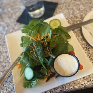 a plate of salad with dressing