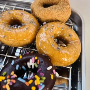 a variety of doughnuts on a cooling rack