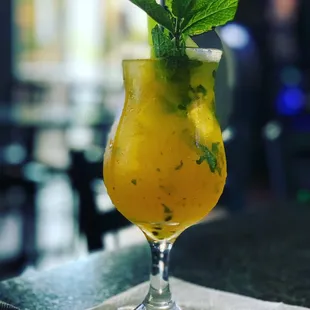 a drink in a glass on a table