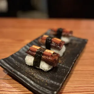 a plate of sushi on a wooden table