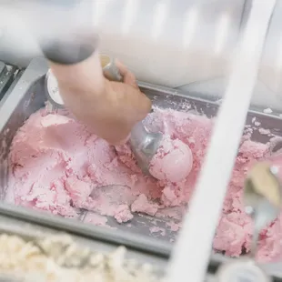 a person scooping a scoop of ice cream