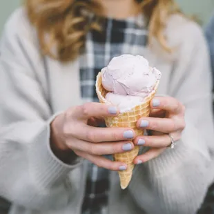 a woman holding an ice cream cone