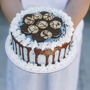 a person holding a cake