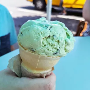 a person holding an ice cream cone