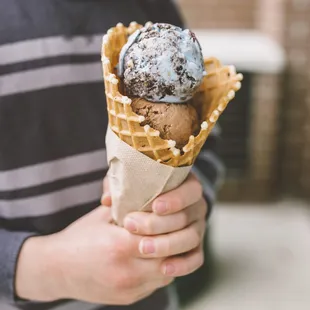 a boy holding a cone of ice cream