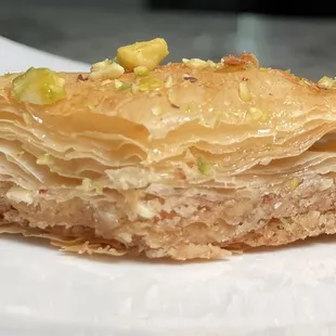 a piece of baklaa on a white plate