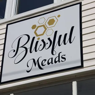 Look for this sign on our building to find us!