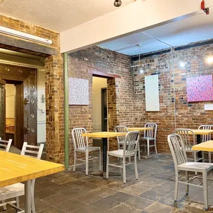 the interior of a restaurant with tables and chairs