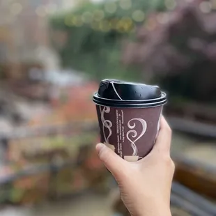 a person holding a cup of coffee