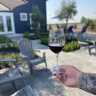 a hand holding a glass of wine