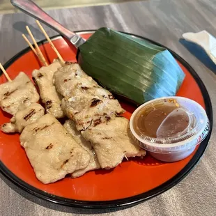 Pork skewers with sticky rice.
