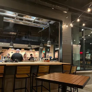 a view of a bar with people sitting at it