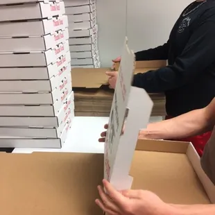 pizza boxes stacked on top of each other