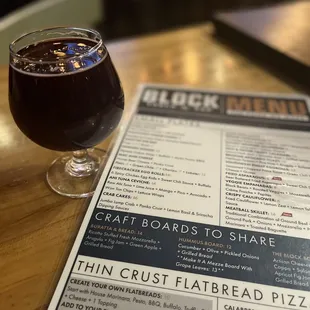 a glass of beer and menu