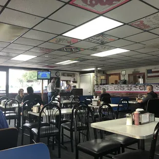 people sitting at tables in a restaurant