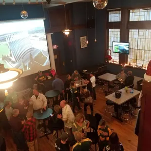 a large group of people sitting at tables in a large room