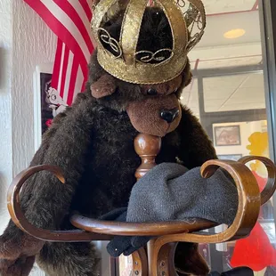 a brown teddy bear wearing a gold crown