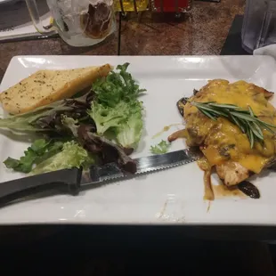 Marinated chicken one breast with salad and garlic bread
