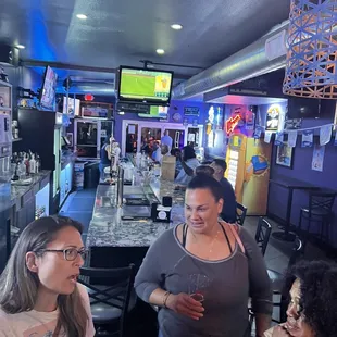 a group of women sitting at a bar