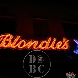 a neon sign in front of a building