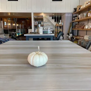 a white pumpkin on a wooden table