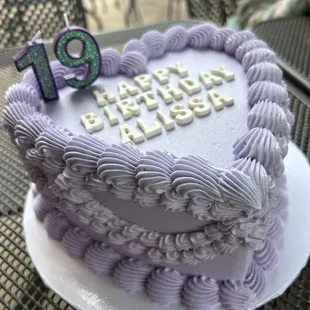 a purple birthday cake on a table