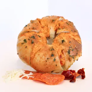 Pizza Bloom Bagel: Dipped in Bloom Butter (honey garlic). Stuffed with cream cheese, sundried tomato, pepperoni, mozzarella, and marinara.