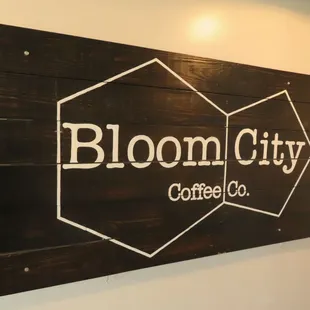 a sign for bloom city coffee company