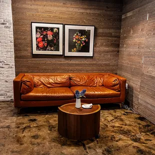 a brown leather couch and coffee table