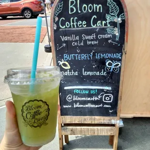 a hand holding a drink