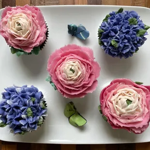 Beautiful display of some of our vibrant floral cupcakes