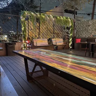 a wooden table on a deck at night