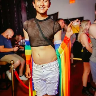 a man in a mesh top and white shorts