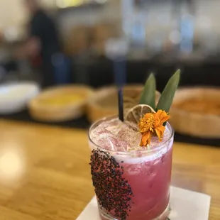 CACTUS BLOOM $16 La Luna Mezcal, fresh prickly pear, pineapple and lime, garnished w black lava salt and fresh lime zest