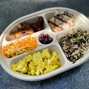 My lunch box. Miso cauliflowers, mixed grains, grilled chicken, sweet potatoes, zucchini noodles and pickled blueberries.