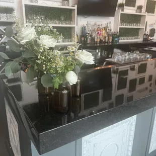 Rehearsal dinner center pieces repurposed in bar area for reception.