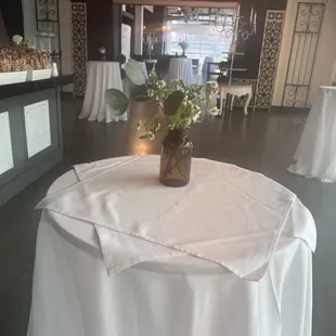 Rehearsal dinner center pieces repurposed in bar area for reception.
