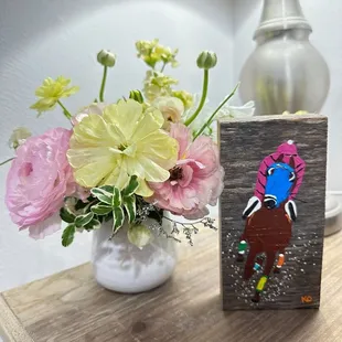 Flower arrangement from Bloomed Roots and a painting from Revelry next door.