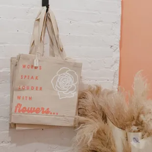 Bloomed Roots canvas tote bags + merch available in store.