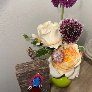 Flower arrangement from bloomed roots and a painting from Revelry next door.