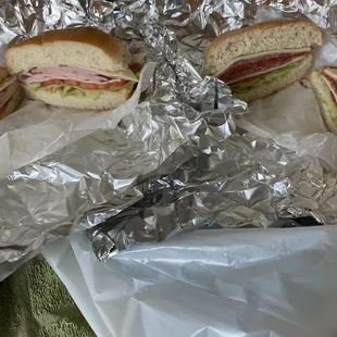 two sandwiches wrapped in tin foil