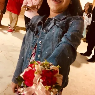 Even at this young age flowers make a girl happy