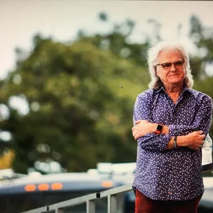  a man standing in front of a bus