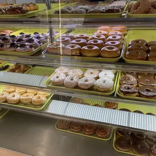 a variety of donuts in a display case