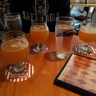 four glasses of beer on a table