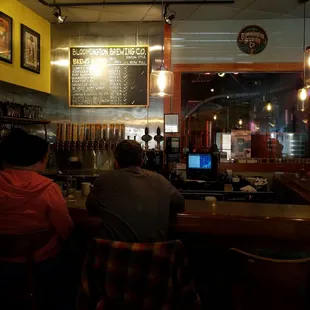two people sitting at a bar