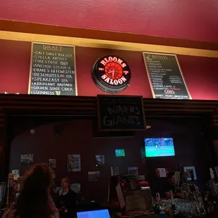 menus on the wall above the bar
