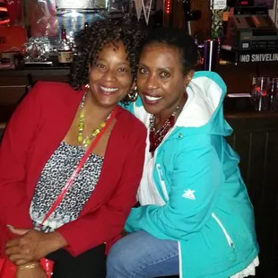 two women sitting at a bar