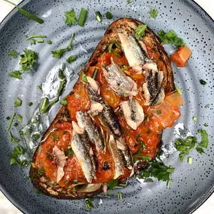 Basque anchovies &amp; tomato toast - blistered tomatoes, roasted peppers, garlic, arbequiña olive oil, herbs