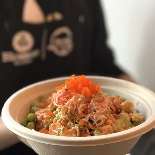 Spicy Salmon- Salmon, avocado, kani salad, green onion, edamame, sesame seeds, onion crisps, spicy mayo